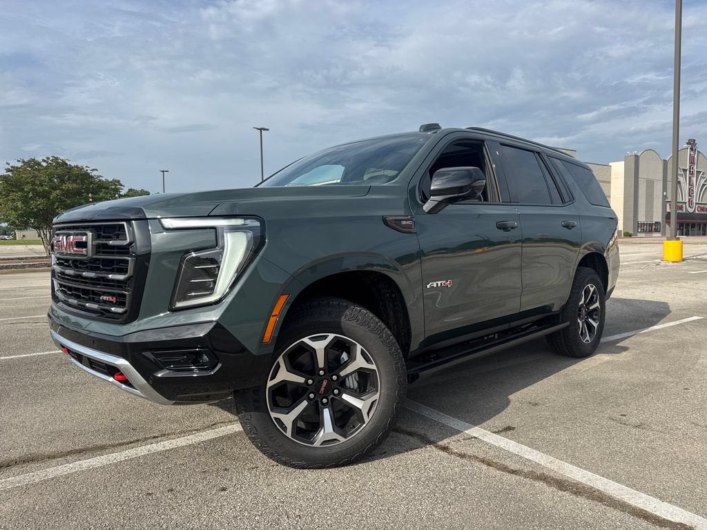 2026 GMC Yukon AT4 Ultimate in Midnight Pine — front three-quarter view