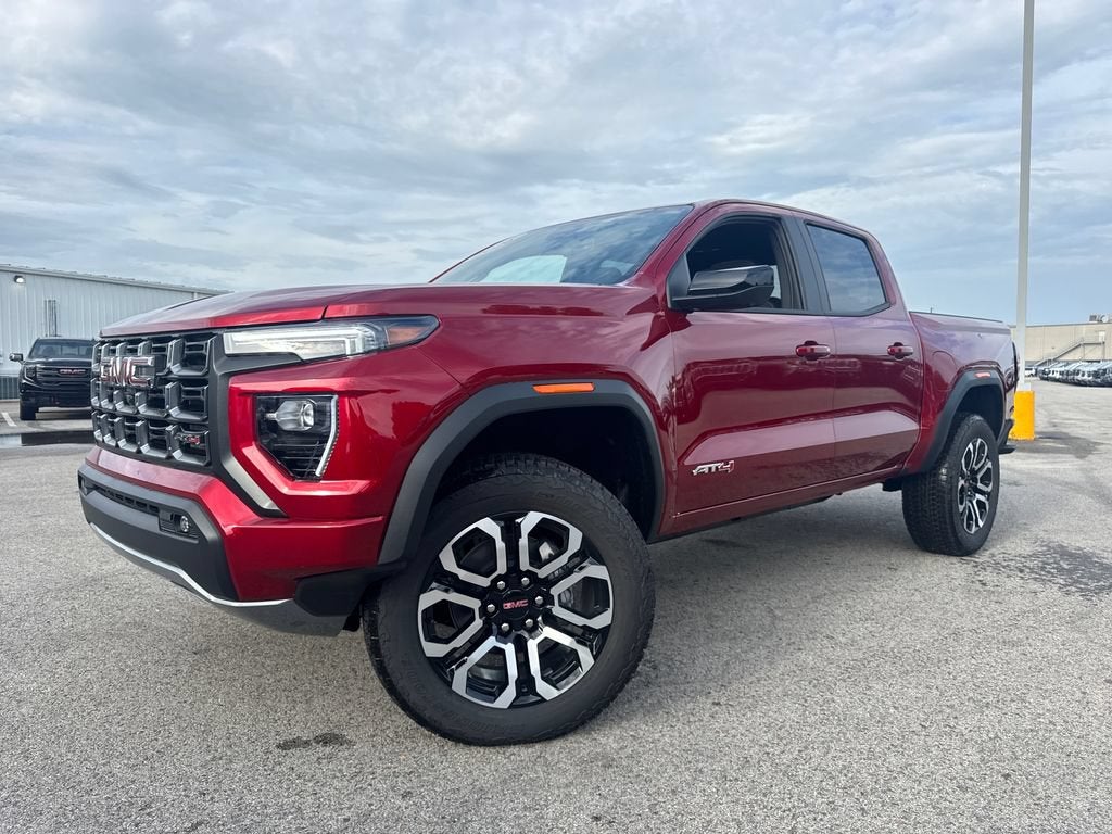 2026 GMC Canyon AT4 in Volcanic Red Tintcoat — front three-quarter view